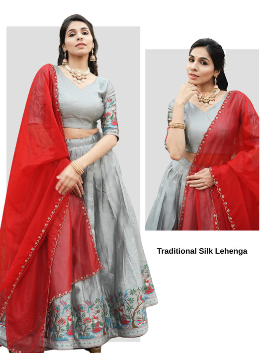 Silver silk traditional lehenga with intricate weaving and a bright contrasting dupatta draped elegantly.