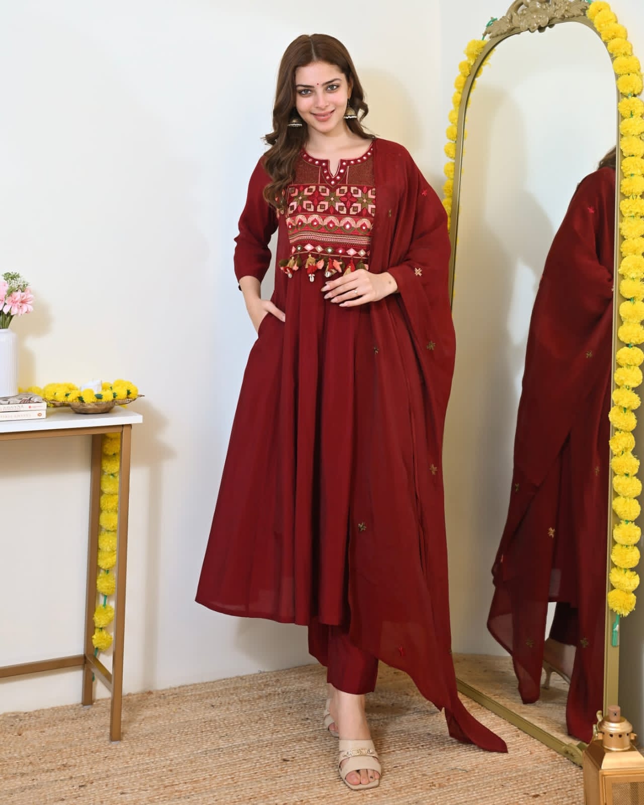 Maroon embroidered Anarkali kurta set with matching dupatta, featuring intricate embroidery and traditional design.