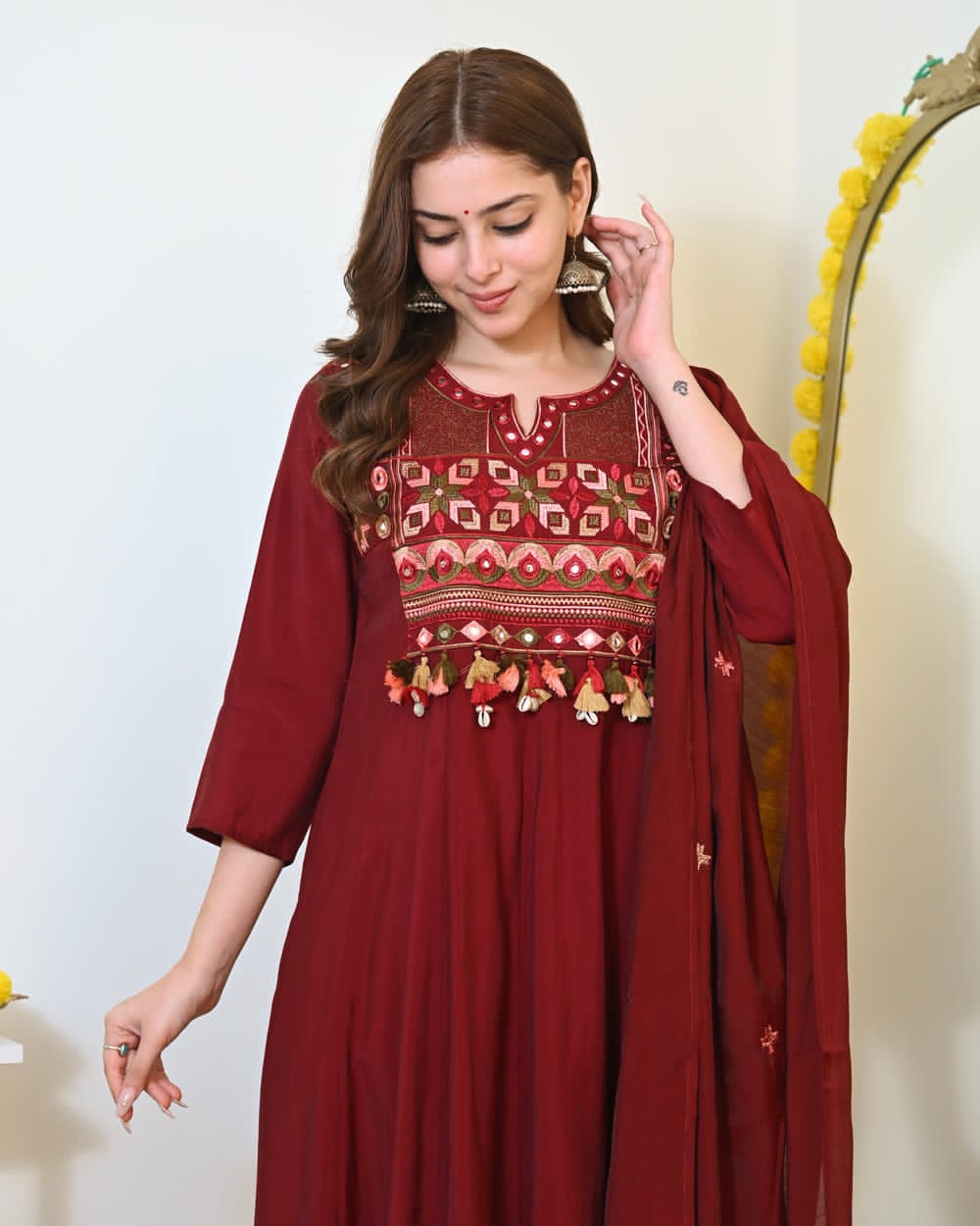Maroon embroidered Anarkali kurta set with matching dupatta, traditional Indian attire with intricate embroidery and elegant design.