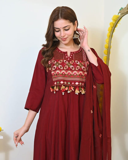 Maroon embroidered Anarkali kurta set with matching dupatta, traditional Indian attire with intricate embroidery and elegant design.